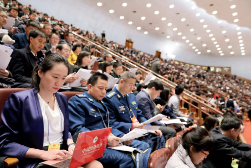 p84(2) 《中国经济周刊》记者张璐晶在十三届全国人大一次会议开幕会上聆听政府工作报告。