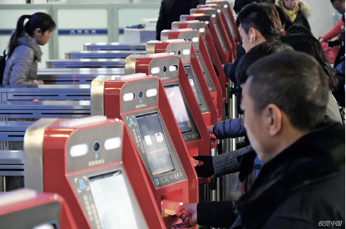 p33 在沈阳北站，乘客通过智能人脸识别系统“刷脸”进站。